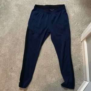Navy blue Nike joggers with black details
